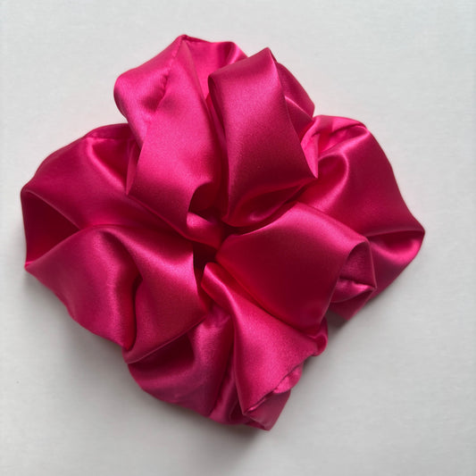 Curlora silk scrunchie for natural hair in fuchsia on marble surface