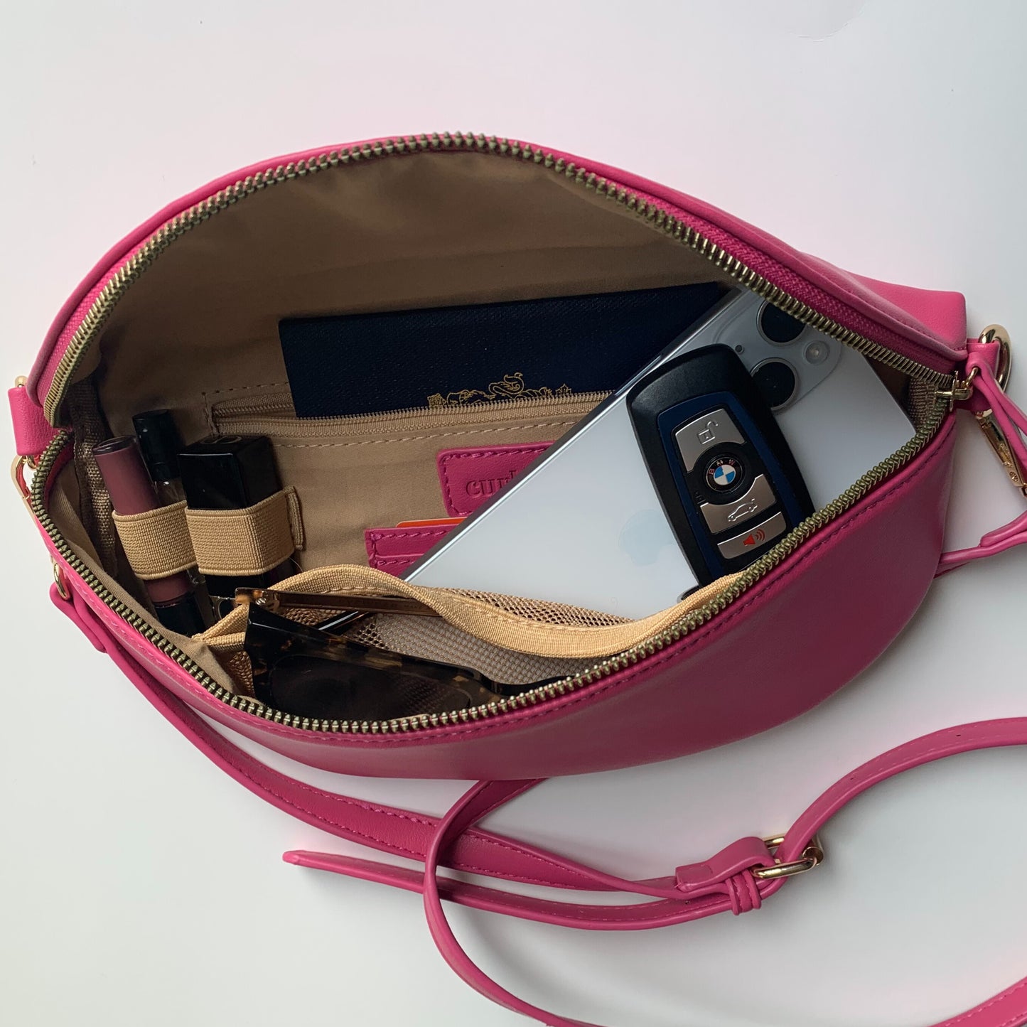 Interior view of Curlora sling bag with storage pockets and phone compartment